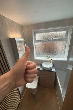 Customer satisfaction after bathroom renovation with modern PVC wall panels