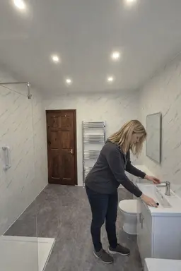 Easy-to-maintain bathroom with PVC wall panels after renovation .